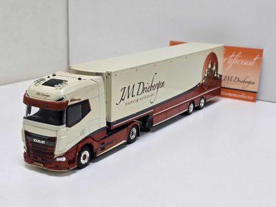 Scale-model DAF semi-truck with a long beige trailer branded 'JM Driebergen' in red lettering on a white and red body.