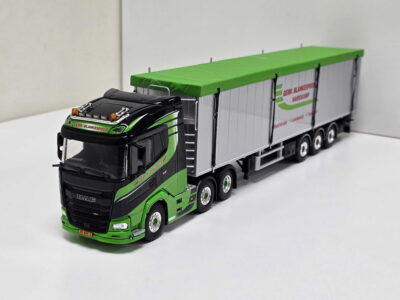 Scale model of a black and green DAF truck with a long silver trailer and bright lime-green roof.