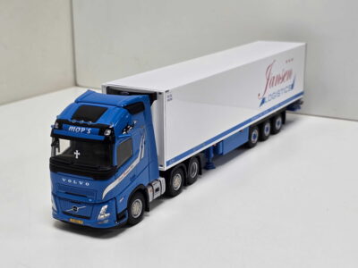 20260523_163044 - Degen Miniaturen Blue Volvo truck model with a white trailer featuring the Jansen Logistics logo, photographed from the front-left angle on a white surface.