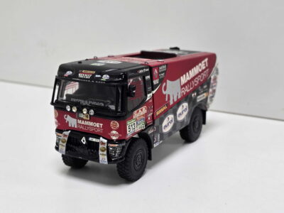 Scale model rally truck with red and black livery and sponsor decals on a white background, front view close-up.