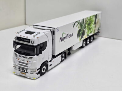 White Scania truck model with a long trailer branded Noviflora in a white studio setting, angled to show the cab and front of the trailer.