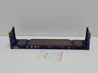 Blue CMA CGM shipping container chassis with brown planks and yellow corner caps, viewed on a white surface.