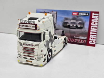 White Scania model truck with roof lights, Van Houten name plaque, and detailed front grille on a white surface; model box visible in the background.