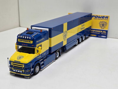 Blue and yellow Scania toy truck with trailer displaying V8POWER.nl branding on a white surface.