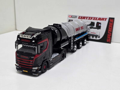 Scale model: black and red Scania cement mixer truck with a large silver mixer, set on a white surface with a boxed background.