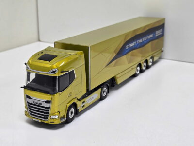 Gold toy semi-truck with a long gold trailer, shown at an angle with 'START THE FUTURE' text on the trailer side and a DAF-style chrome grille at the front.