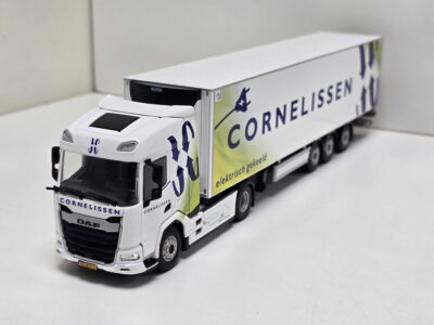 White toy DAF semi-truck with a long trailer labeled CORNELISSEN, placed on a white surface.